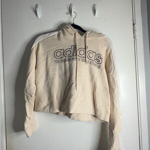 Cream and white Adidas cropped hoodie with a relaxed fit